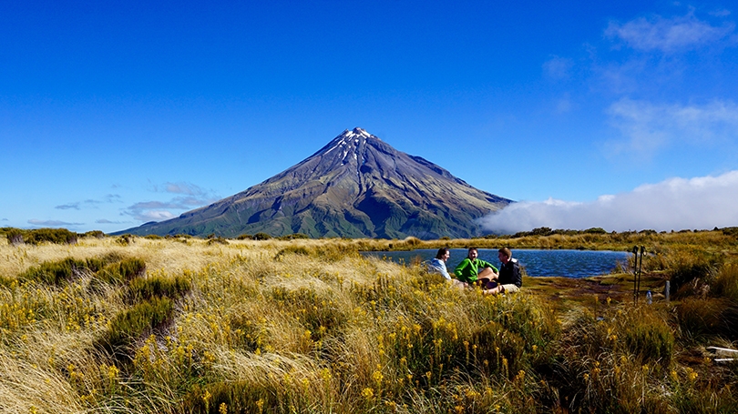 students sitting at the base of a volcano in New Zealand